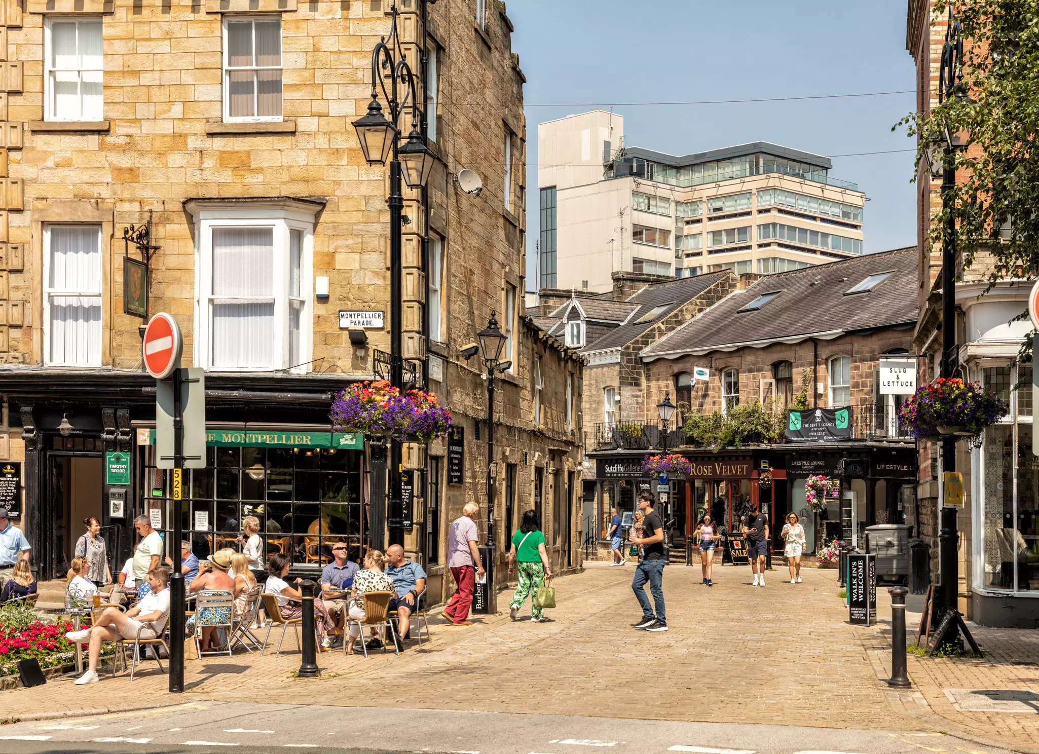 A lively UK town with people sitting outside bars