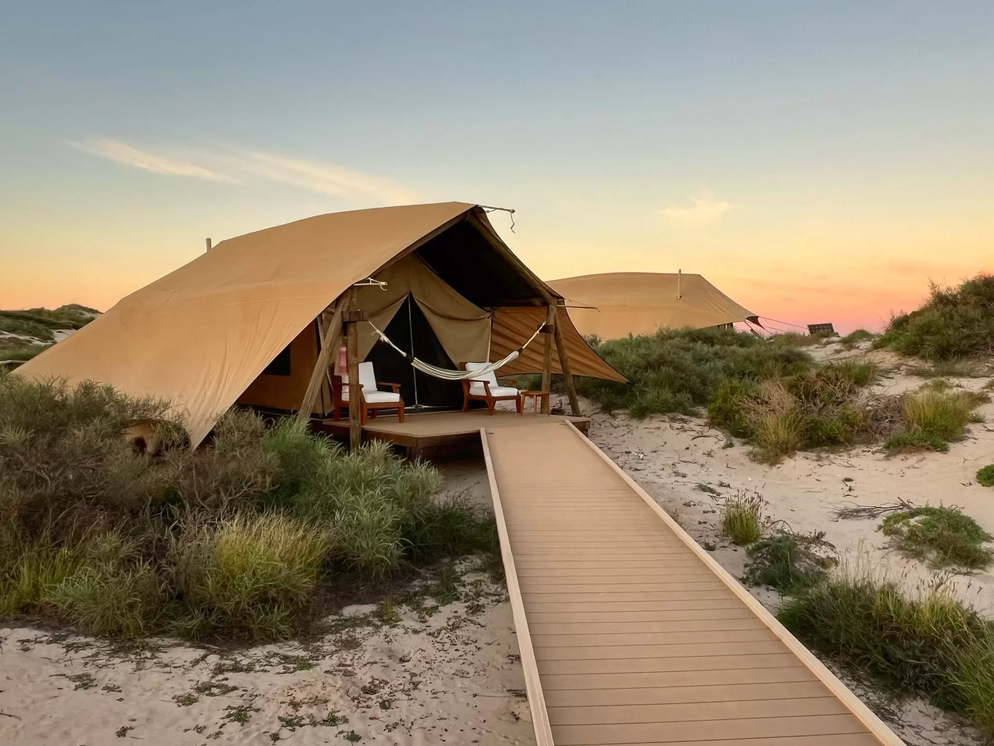 A safari tent sits in the sand dunes in Western Australia.