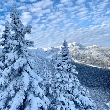 Beautiful sunny day with blue sky and white clouds at the Stowe Mountain Ski resort Vermont - December 2020