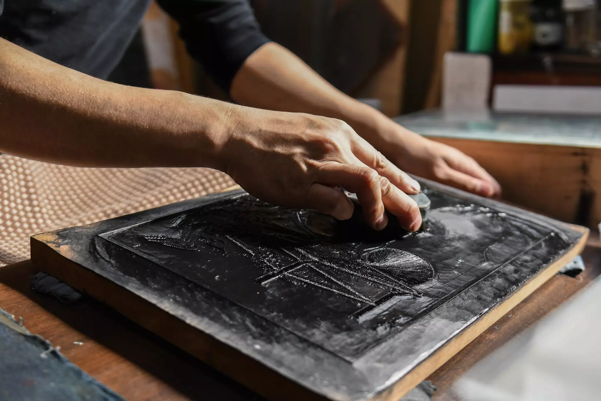 Making a woodblock print with ink.