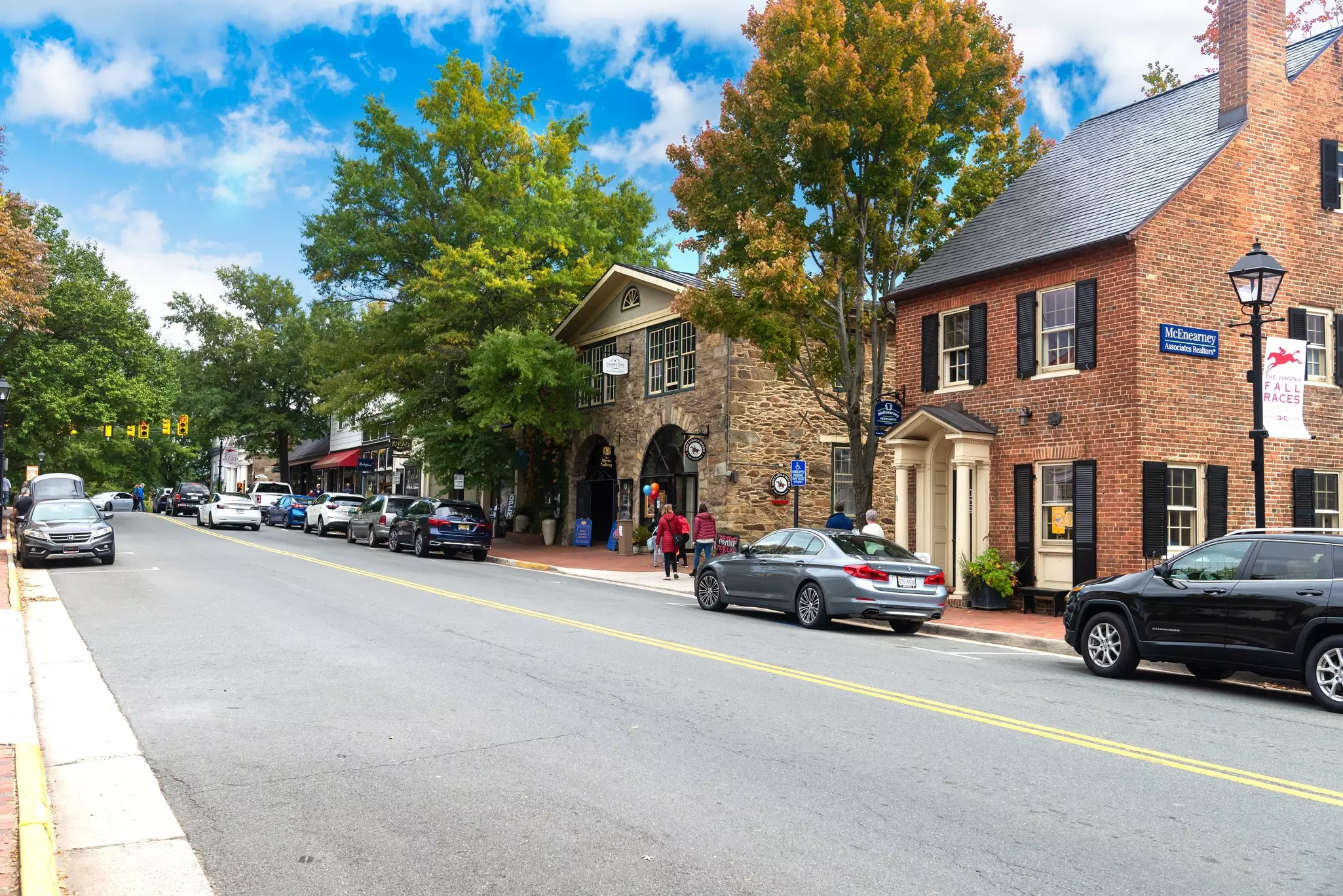 A street in Middleburg Virginia lined with cars.