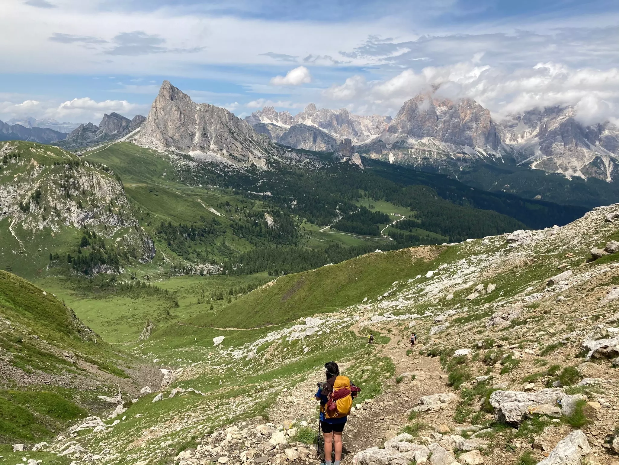Hiker taking in the view of the Dolomites in the Italian Alps while hiking the Alta Via 1.