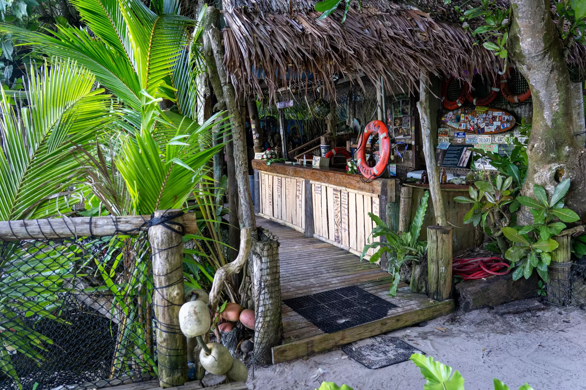 A wooden outdoor bar surrounded by trees.