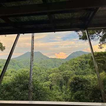 A view across jungle towards two volcanic rims