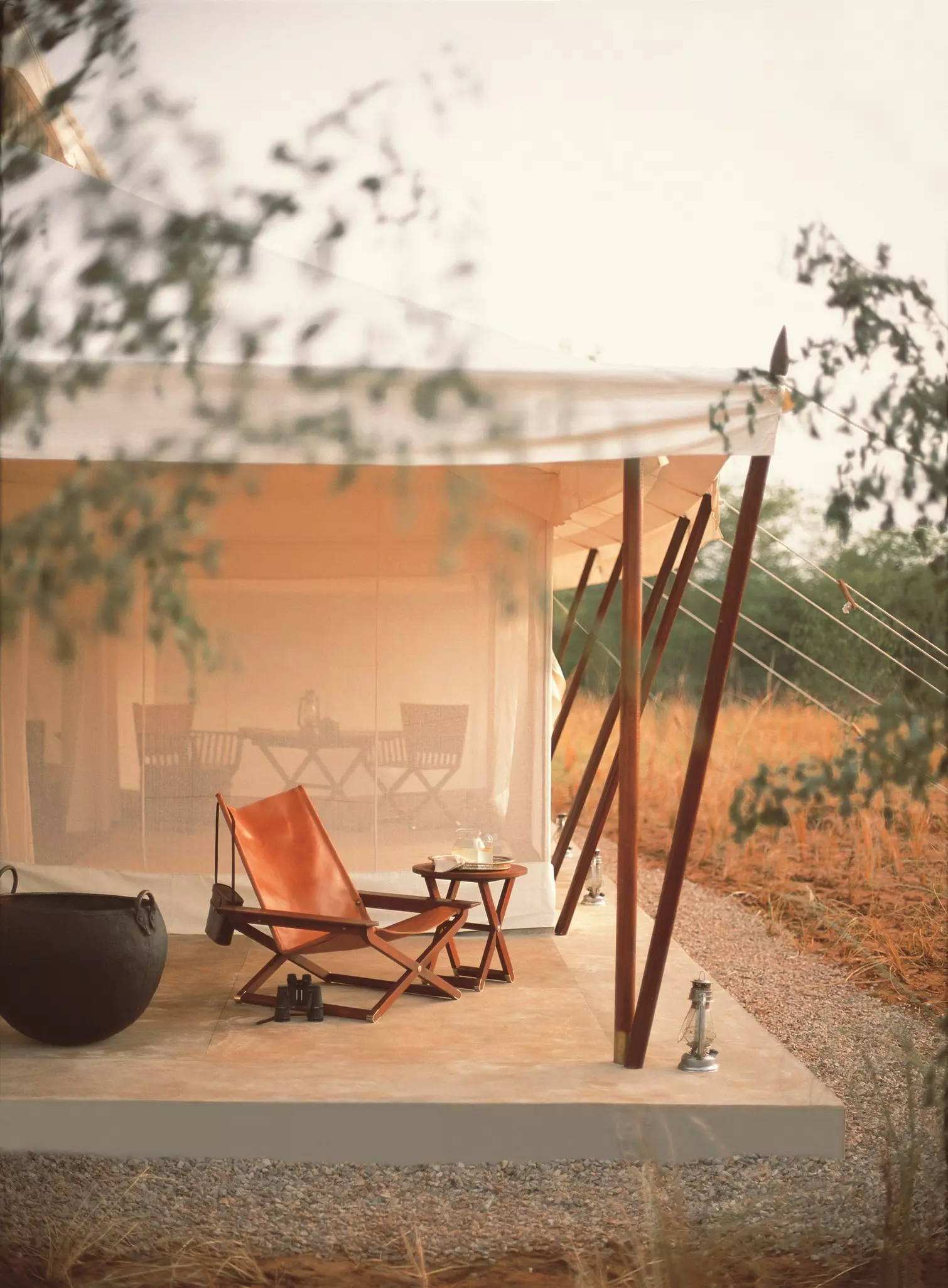 A chair on a viewing deck outside a luxurious tented camp
