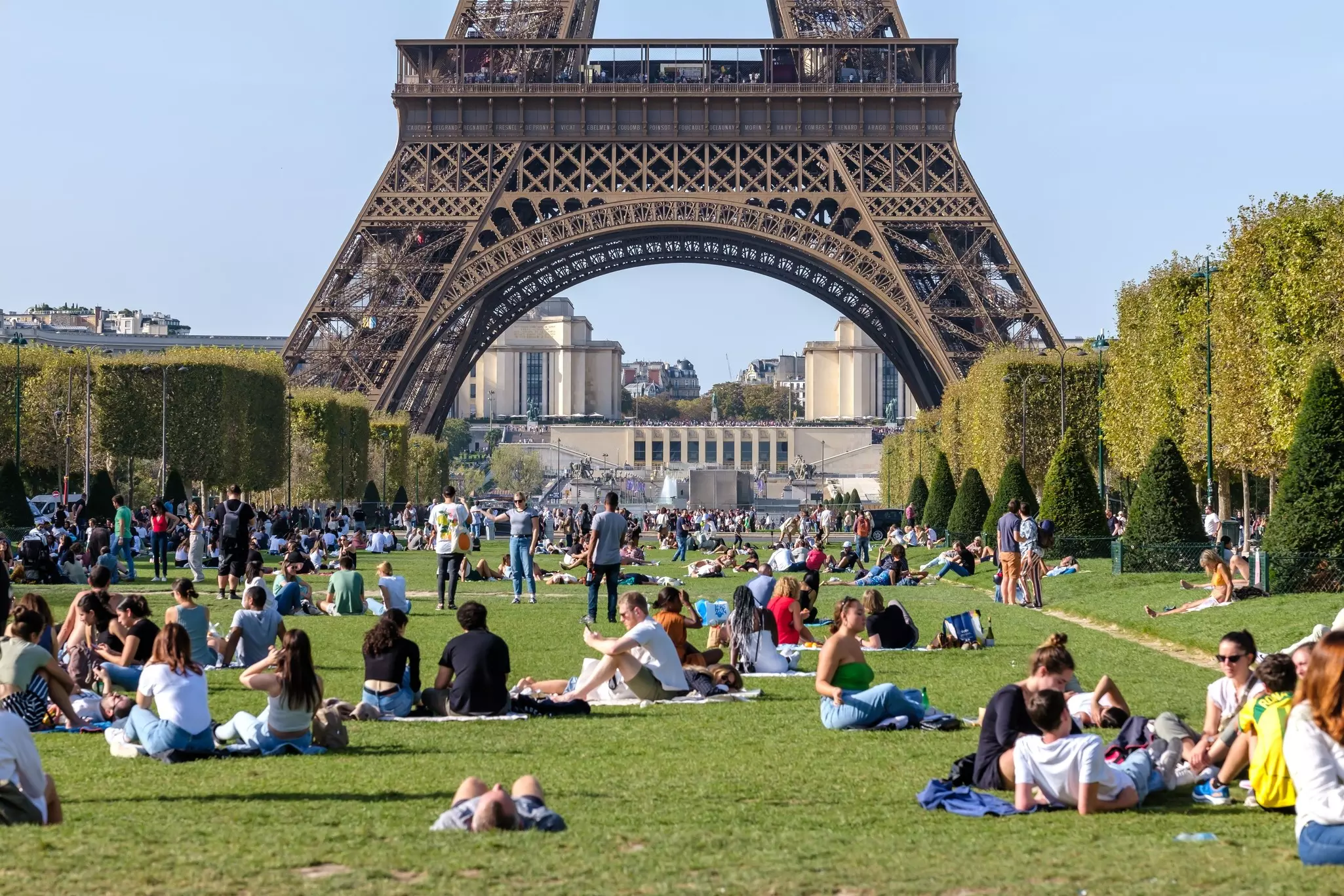 Panoramic view of the Champ de Mars, Field of Mars, a large public green space with people in Paris France