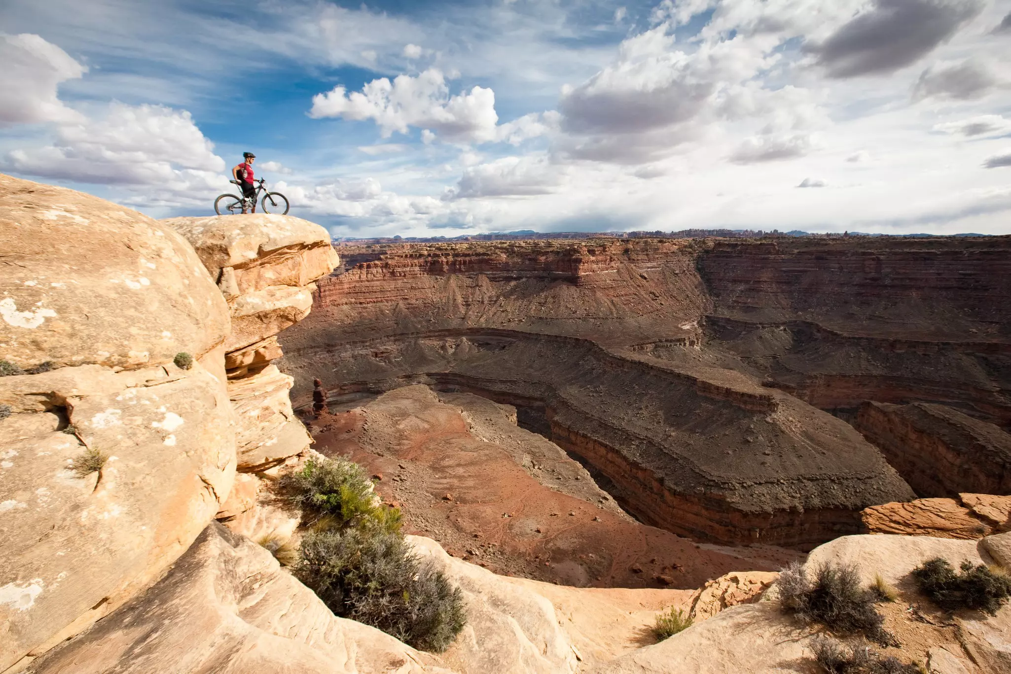 A mountain biker at the Colorado River overlook, Canyonlands National Park, Utah, USA.