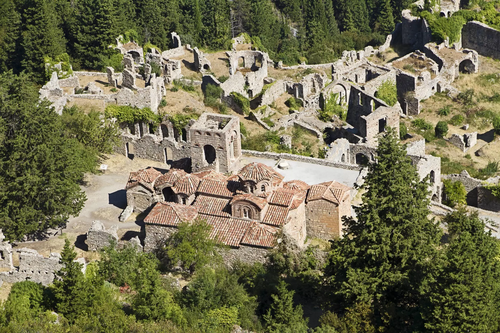 An aerial view of a number of small stone houses and walls in the lower part of Mystras, Greece.