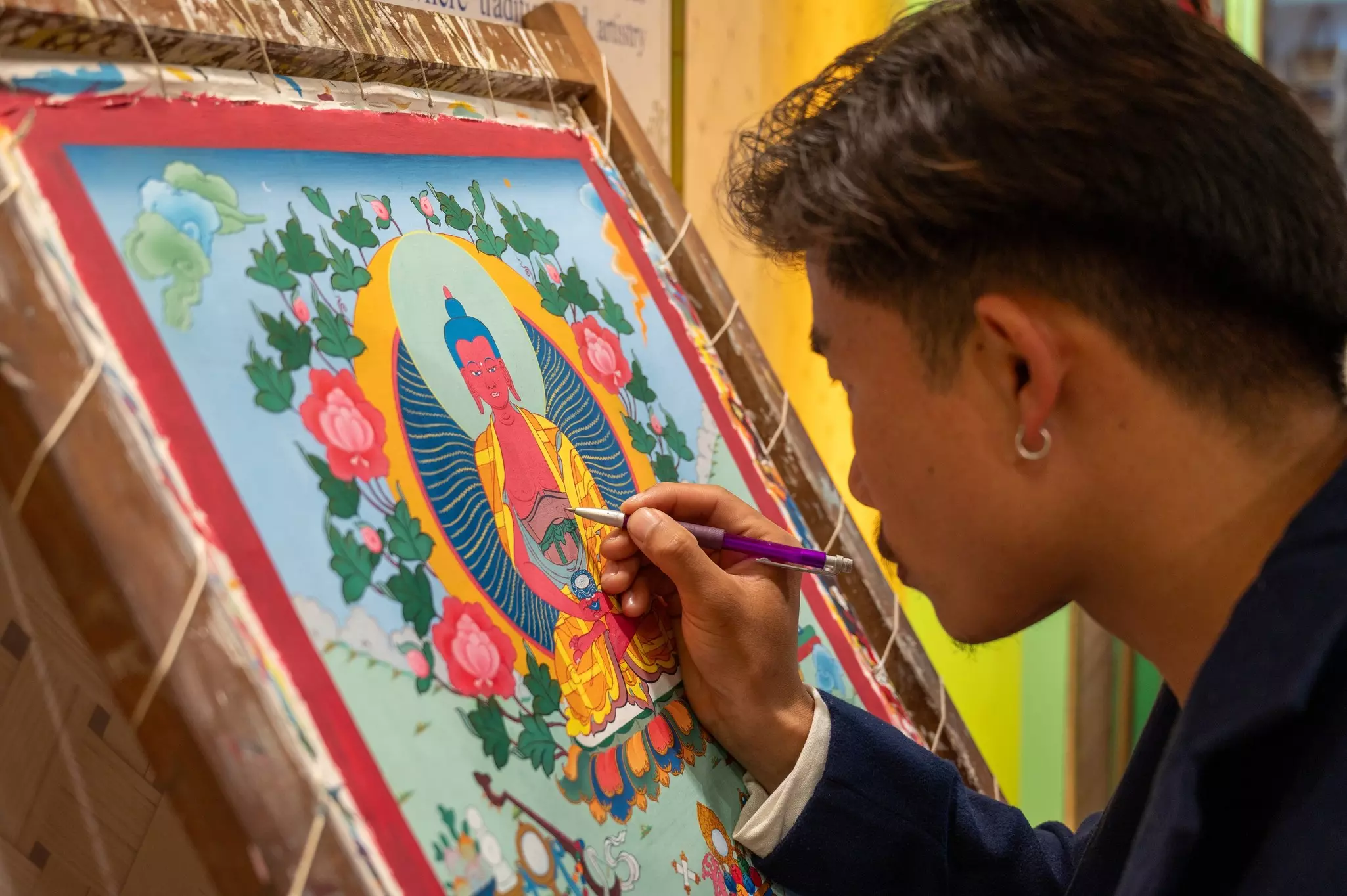 An Indian artisan creating a thangka painting