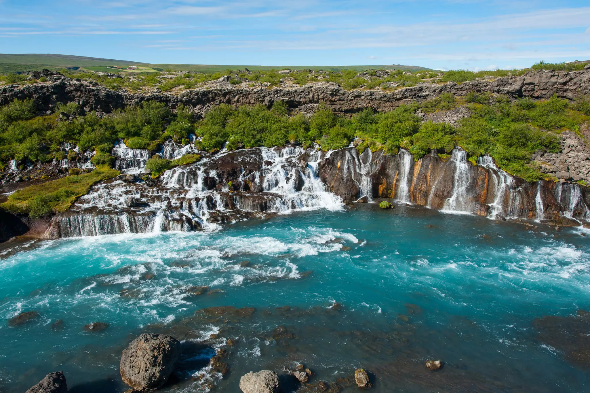 Waterfalls dot the landscape close to Húsafell, Iceland.