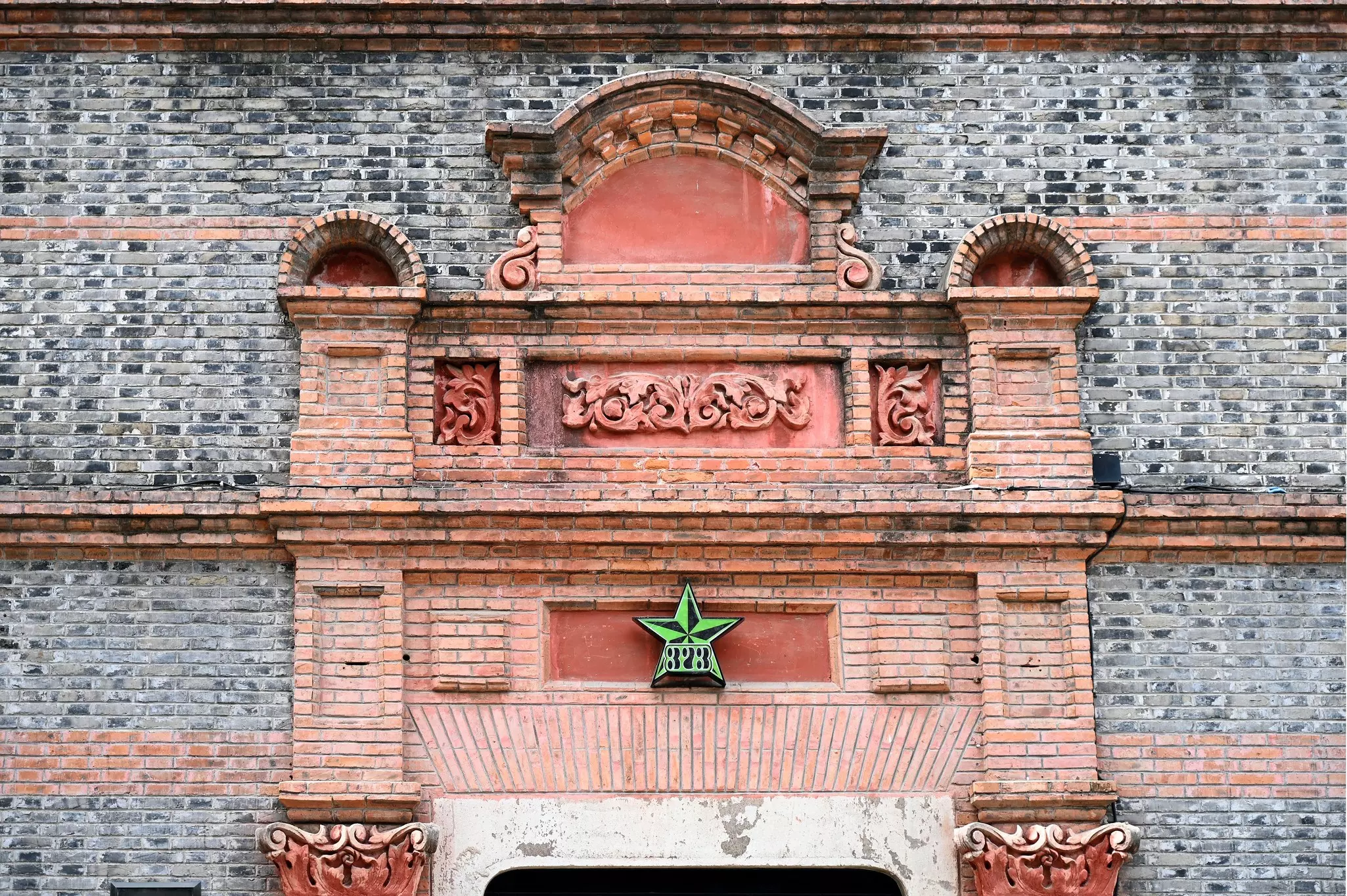 Close up of the arched carved stone gate of an old building in Xintiandi