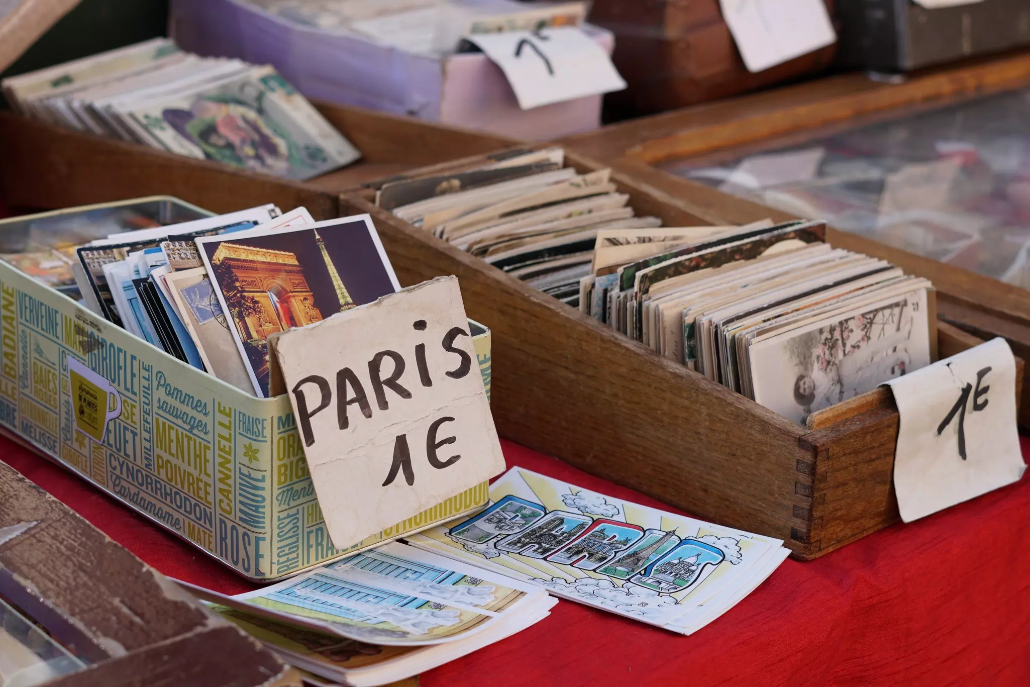 A series of old-fashioned postcard designs for sale for a euro at a market stall