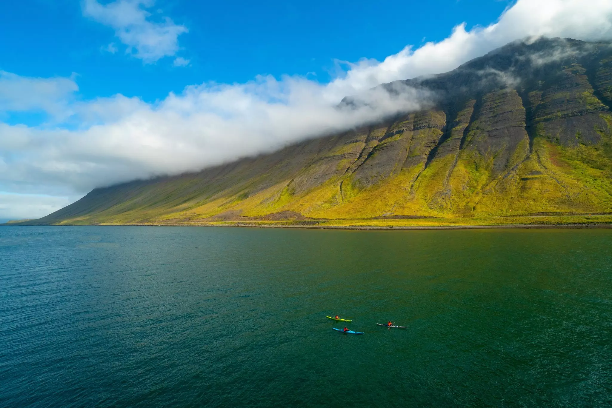 Kayakers in Skutulsfjordur Fjord at Ísafjörður, Iceland. 