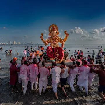 Celebrating Ganesh Chaturthi, Mumbai, India. Sandycinecam/Shutterstock