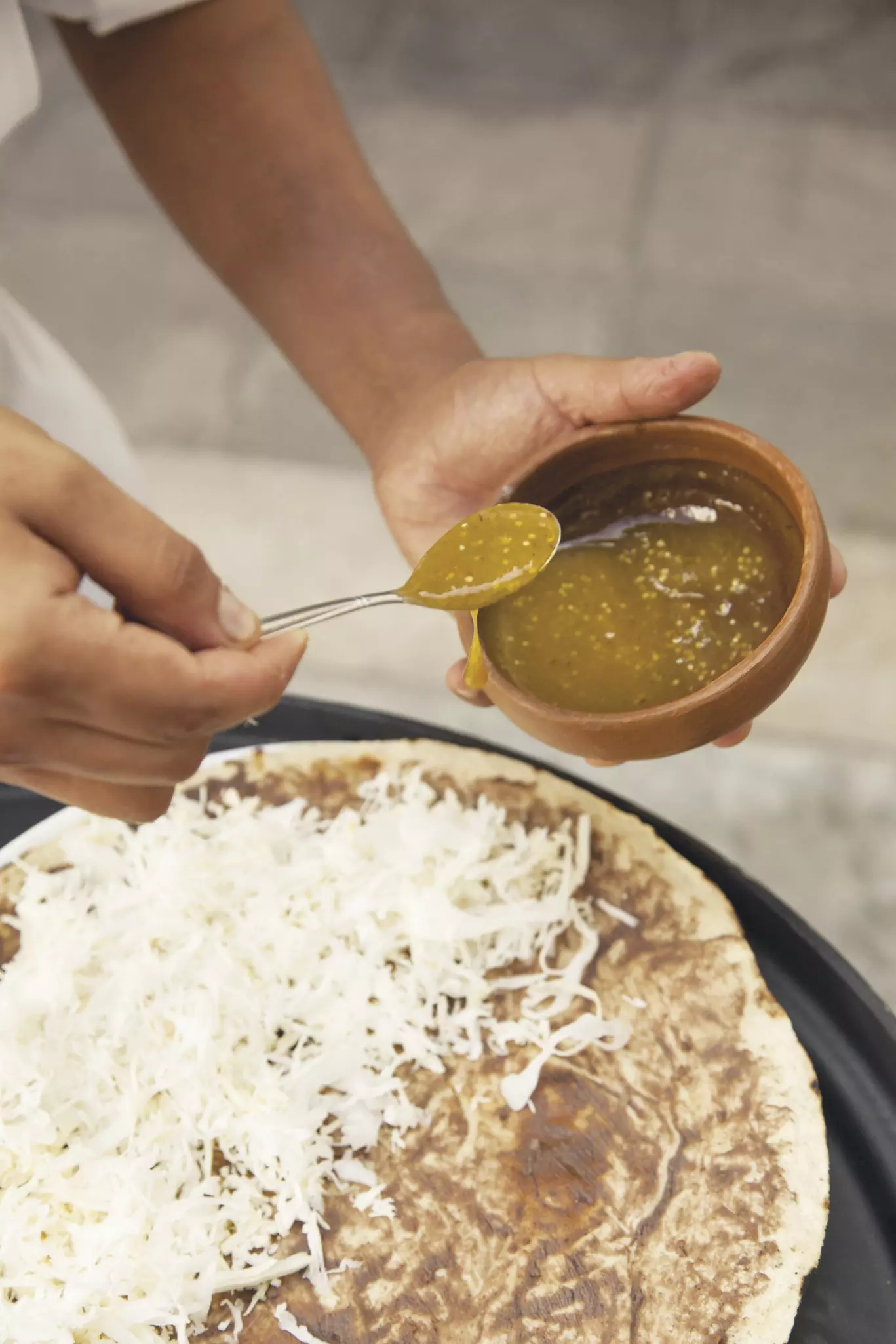 From The Source, Mexico, food
Preparing Tlayuda (Giant tortilla with topping) at Casa Oaxaca El Restaurante.