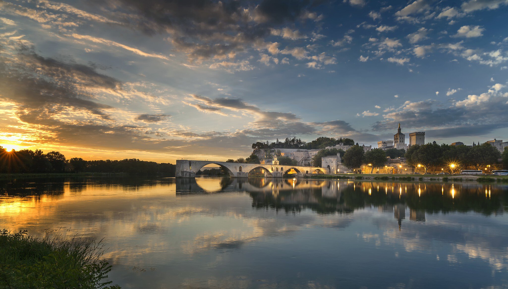 Arch bridge over river at sunset, Avignon, France