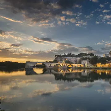 Arch bridge over river at sunset, Avignon, France