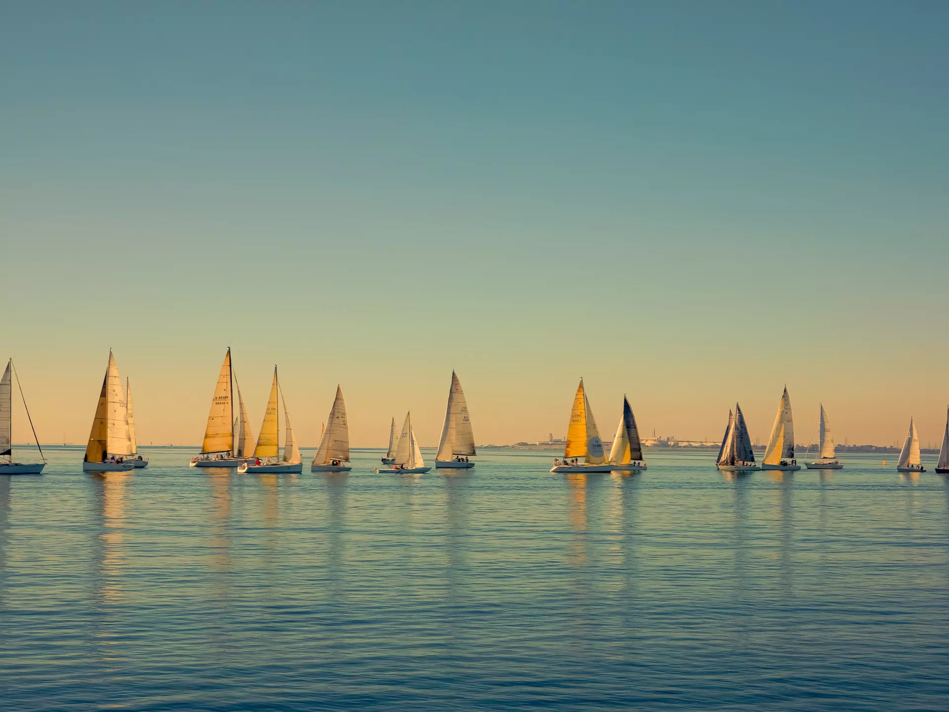 Sailboats scattered on the ocean, seen from The Pier in Geelong, Australia