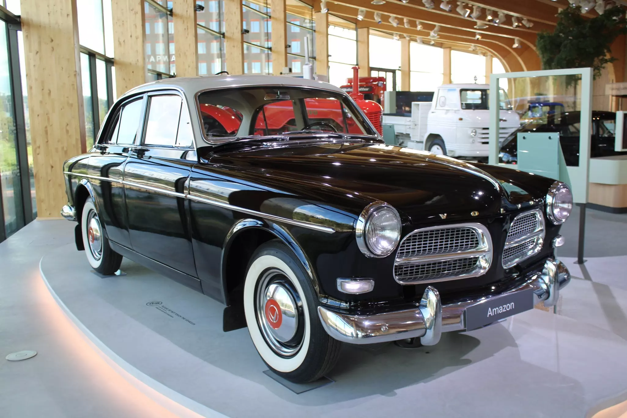 An antique black sedan is on display at an automotive museum.