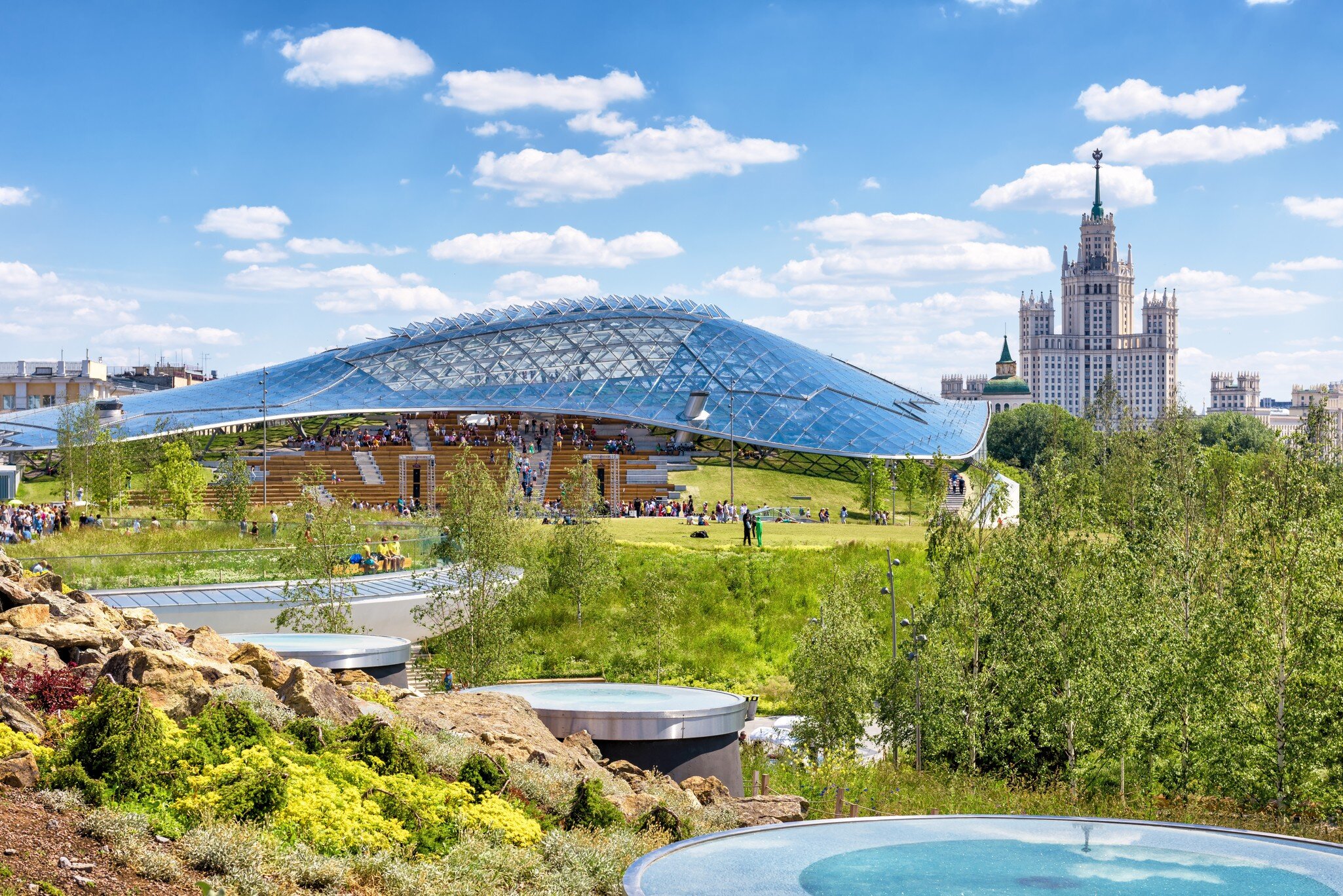 Zaryadye Park with modern amphitheater, Moscow, Russia. Zaryadye is new tourist attraction of city. Scenic view of Zaryadye, nice landscaped park in summer. Urban landscaping. Moscow - June 16, 2018; Shutterstock ID 1119707165;