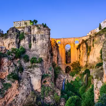 Ronda, Spain at Puente Nuevo Bridge at dusk.