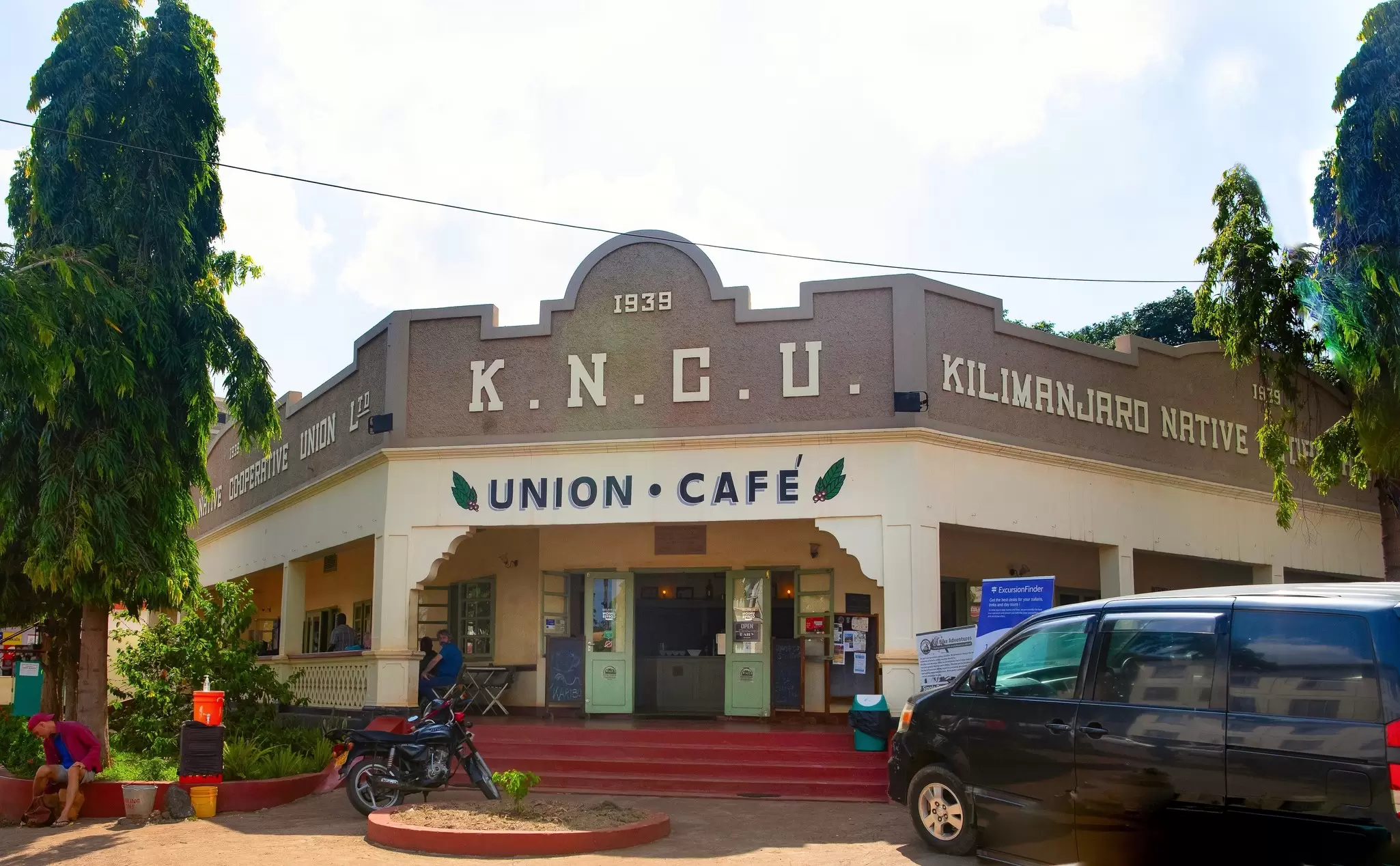 The facade of a cafe in a historic building in a city.