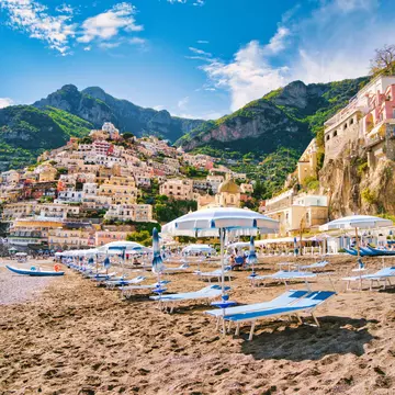 Looking at the beach of the famous village of Positano on the Amalfi coast. Many of the small villages along the Amalfi coastline are hundreds of meters above sea level, because of the geographical reasons. The Amalfi coast is a stretch of coastline on the northern coast of the Salerno Gulf on the Tyrrhenian Sea, located in the Province of Salerno of southern Italy. The Amalfi Coast is a popular tourist destination for the region and Italy as a whole, attracting thousands of tourists annually. In 1997, the Amalfi Coast was listed as a UNESCO World Heritage Site.
1211564544
Positano Beach
