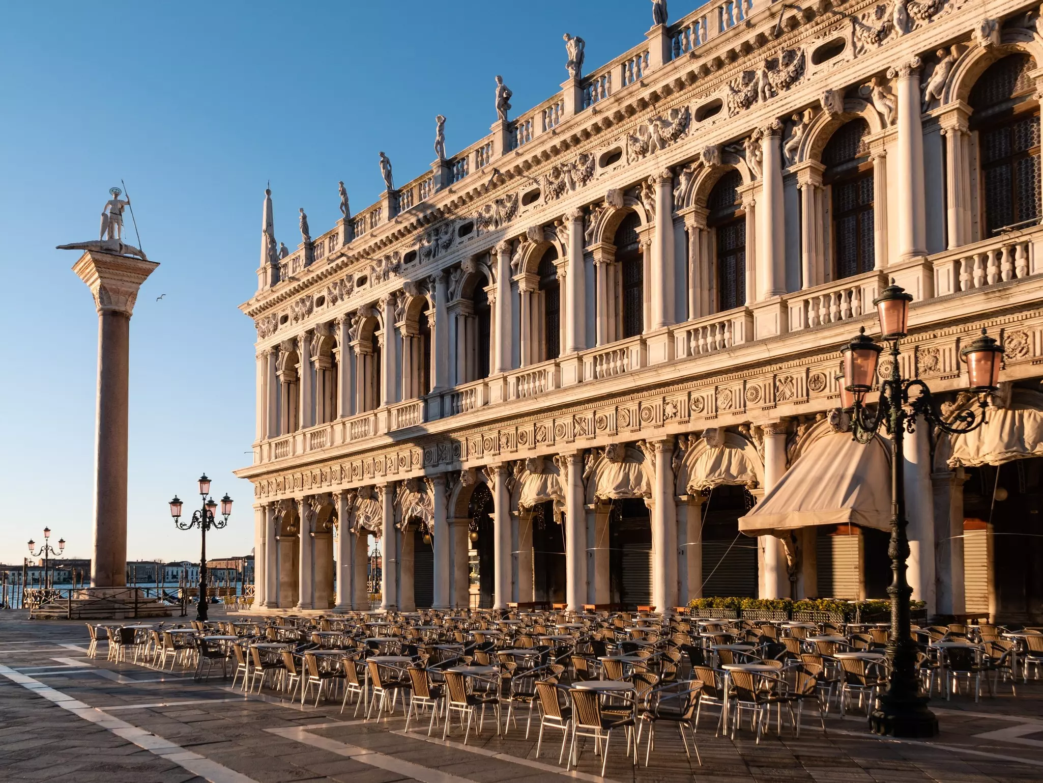 Venice, Italy - January 7 2022: Marciana Library also called Library of Saint Mark or Libreria sansoviniana and Column of San Todaro on Saint Mark's Square or Piazza San Marco