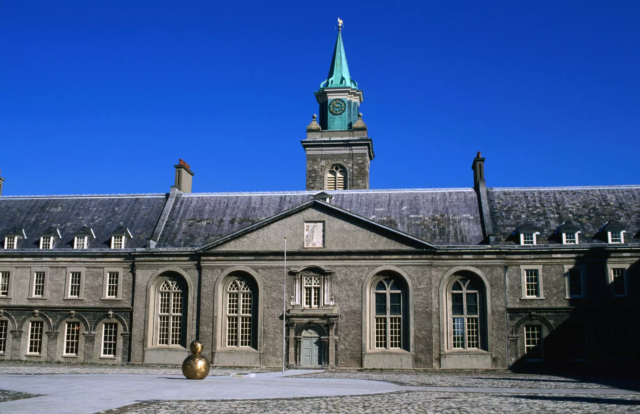Exterior of the Irish Museum of Modern Art, a stone building with rounded windows and a clocktower.