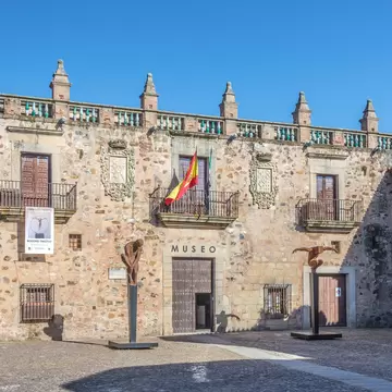 View of the Museo de Cáceres on a sunny day in Spain.