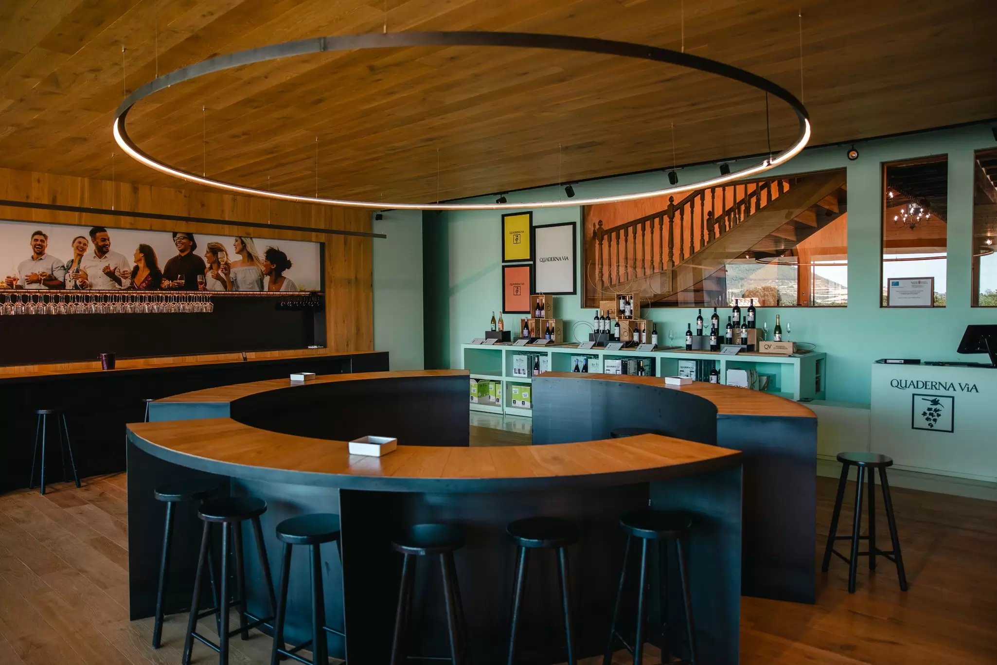 A wine-tasting room with seats around a round central bar: Quaderna Via, La Rioja, Spain.
