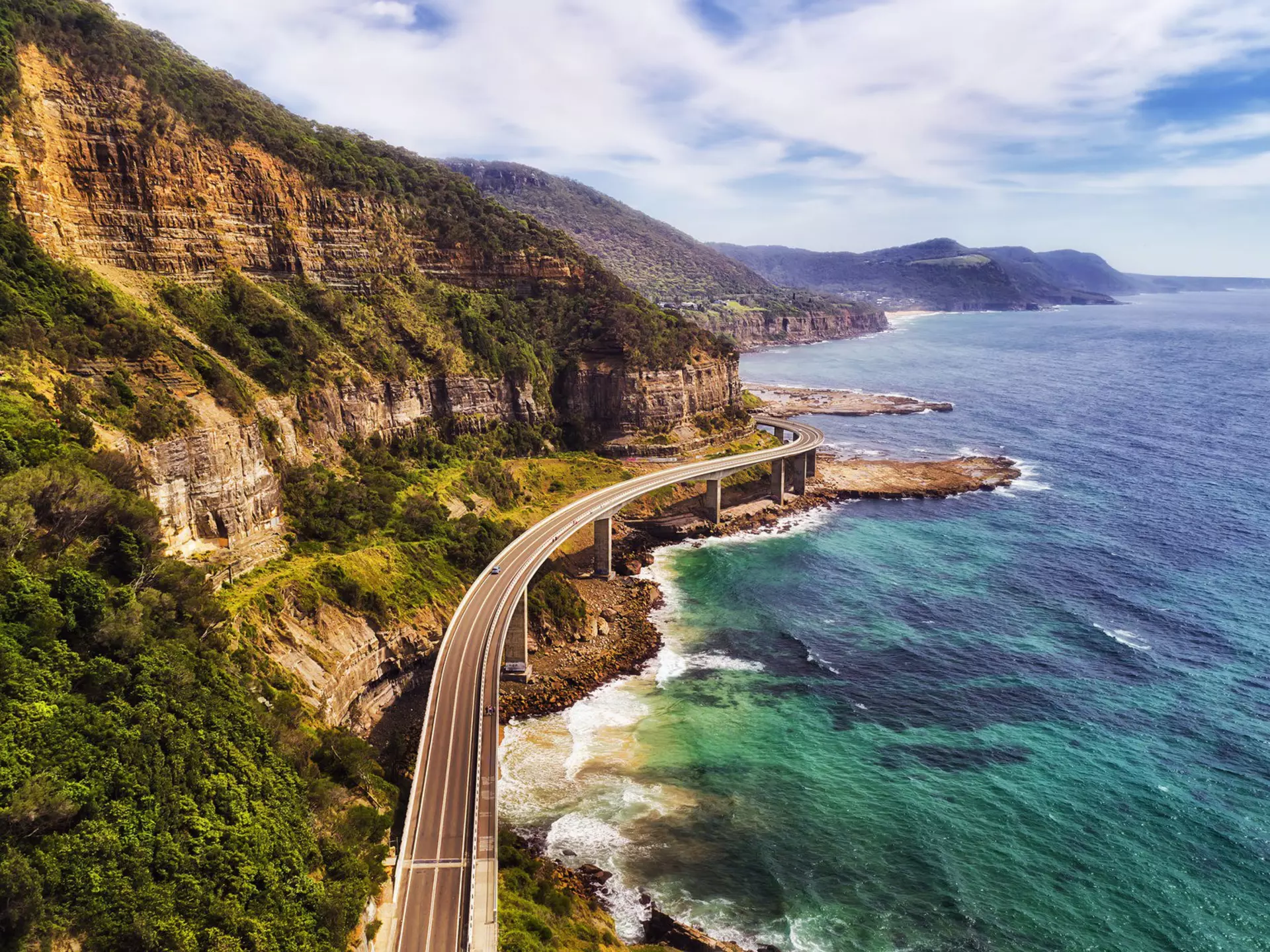 From short scenic drives to epic countrywide journeys – like National Hwy 1, which takes you over the Sea Cliff Bridge south of Sydney then around the entire country – these are 10 of the best road trips in Australia. Taras Vyshnya/Shutterstock