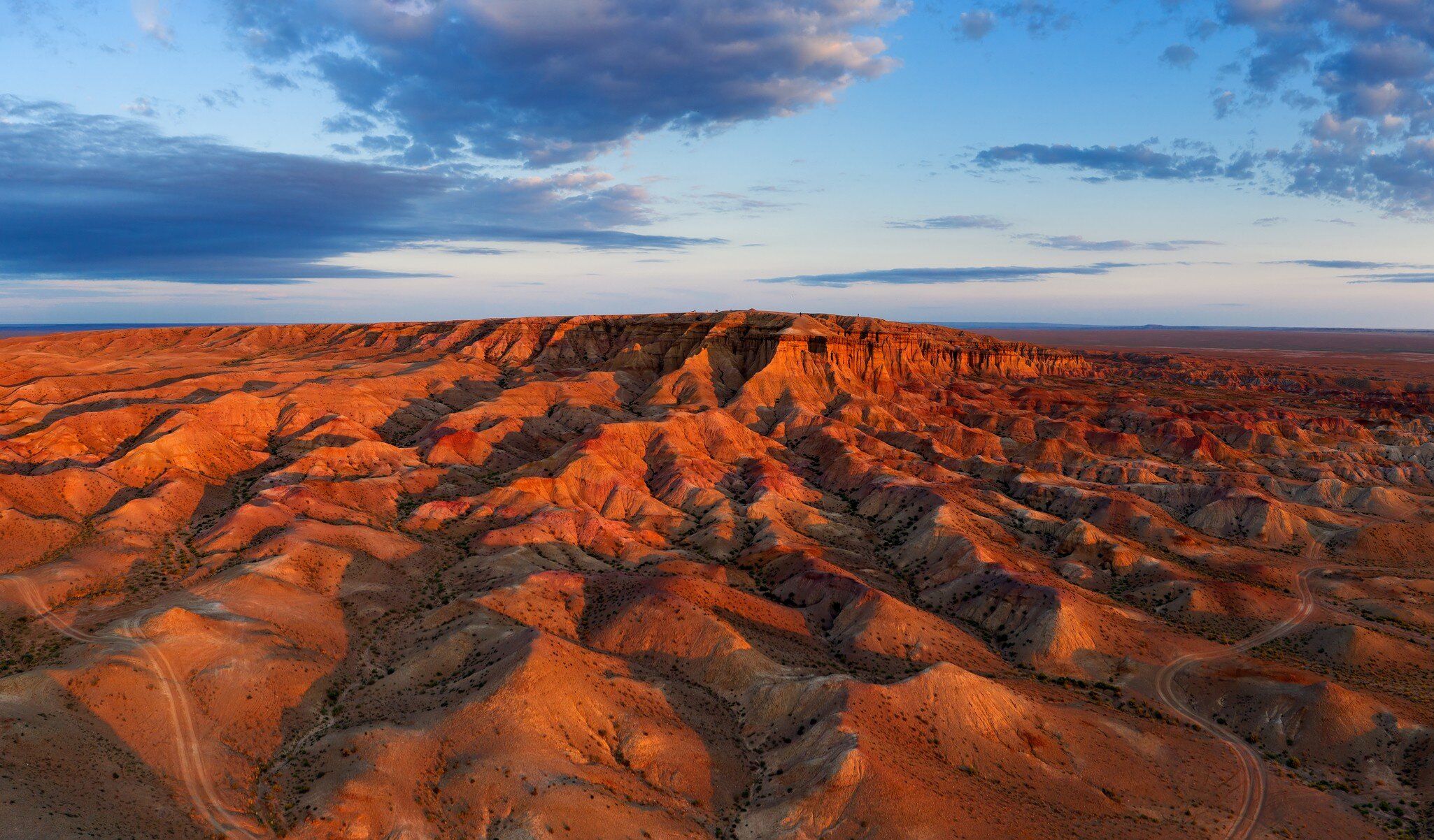 Aerial panorama of textural colorful striped canyons Tsagaan suvarga - White stupa at sunrise. Ulziit soum, Dundgovi province, Mongolia