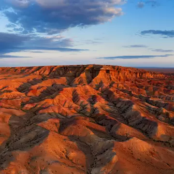 Aerial panorama of textural colorful striped canyons Tsagaan suvarga - White stupa at sunrise. Ulziit soum, Dundgovi province, Mongolia