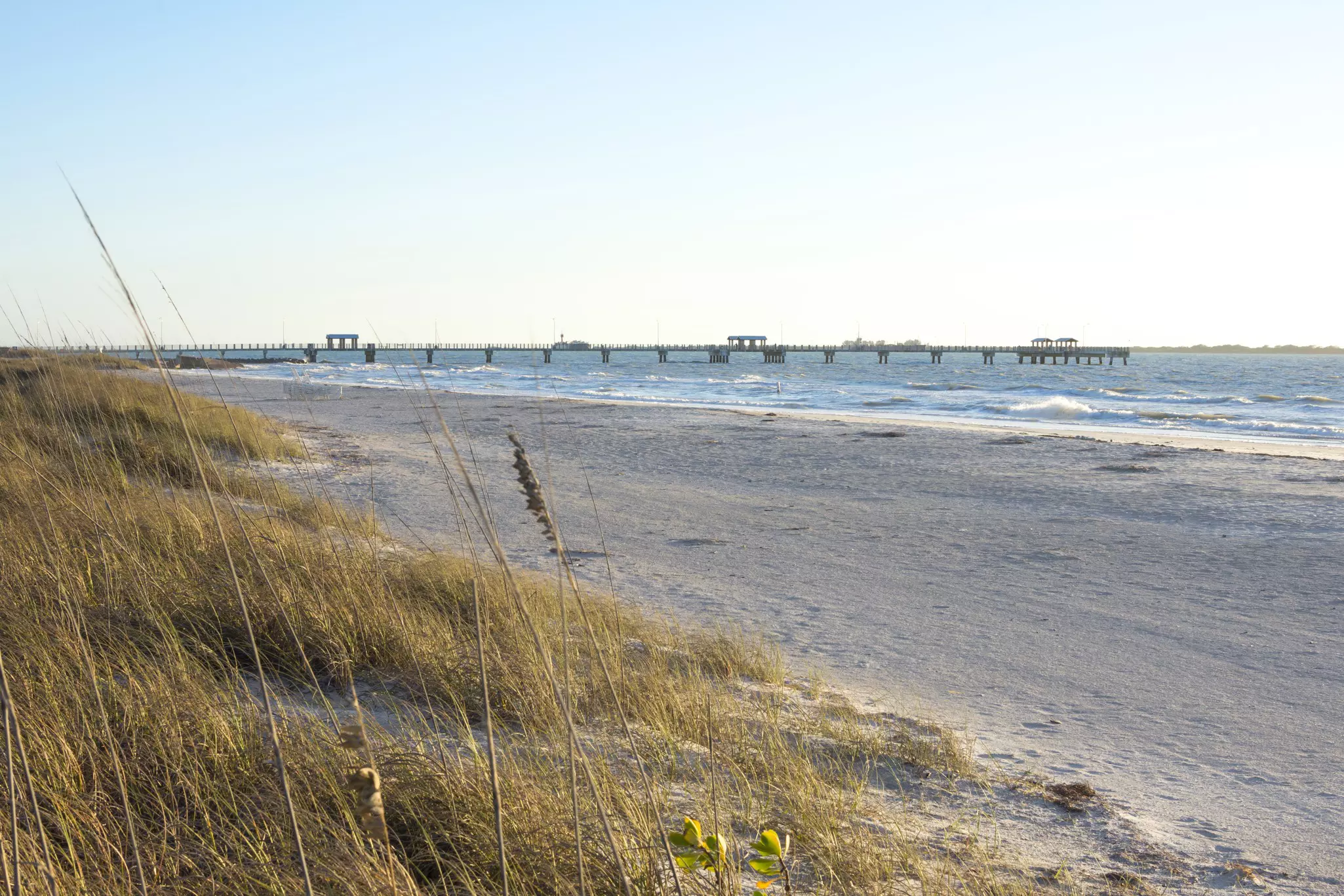 The fishing pier and beach at Fort DeSoto Park on a clear sunny day