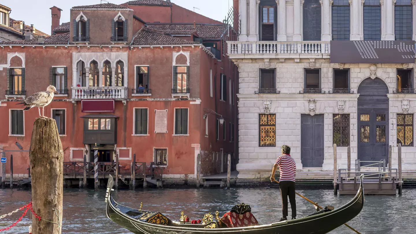 A gondola sails on the Grand Canal near the Hotel San Cassiano and the Prada Foundation