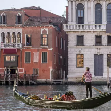 A gondola sails on the Grand Canal near the Hotel San Cassiano and the Prada Foundation