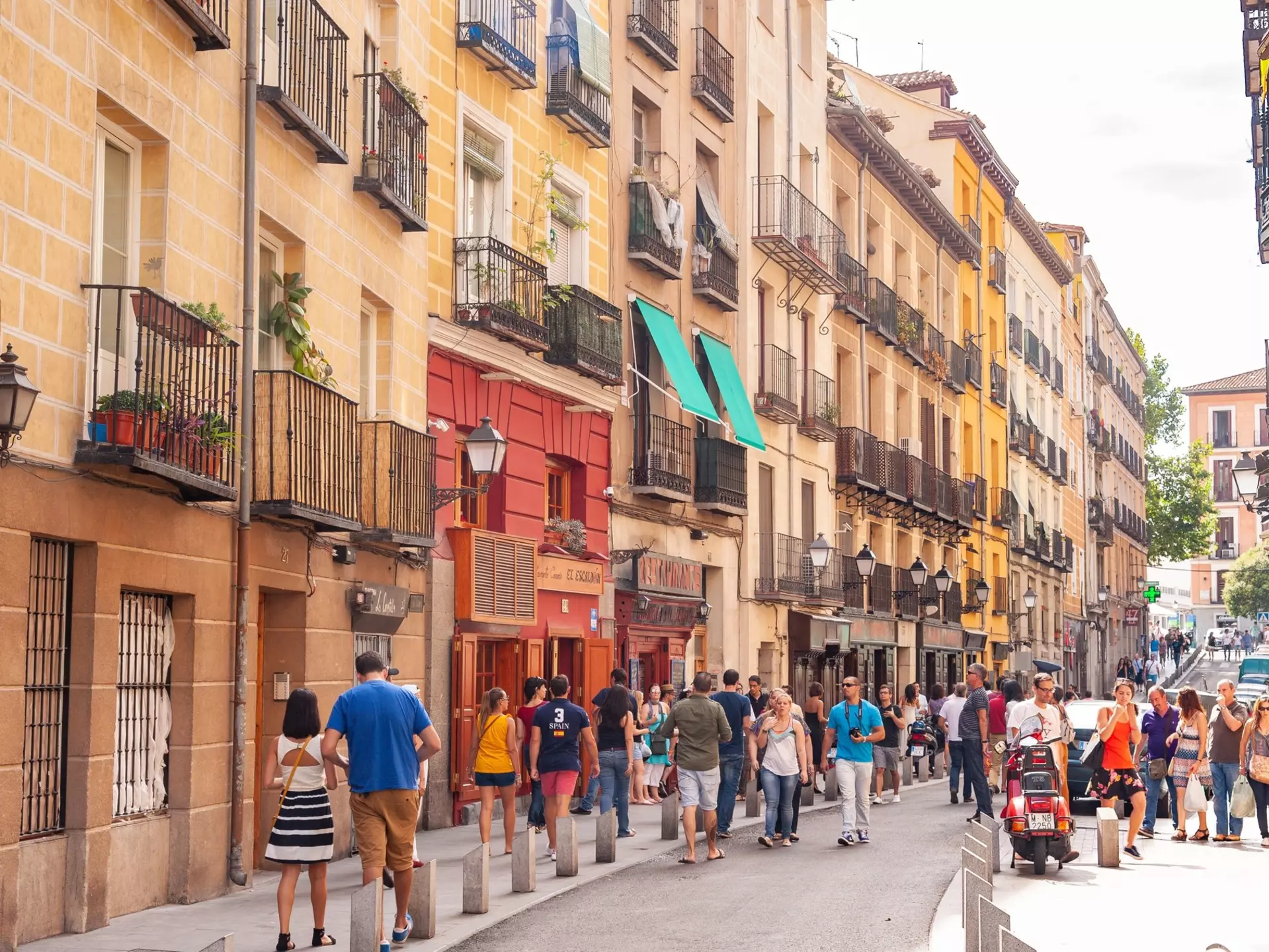 People walking down the popular city centre street Calle Cava Baja in La Latina, Madrid.