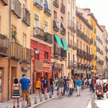 People walking down the popular city centre street Calle Cava Baja in La Latina, Madrid.