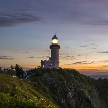 View of lighthouse on cliff at dusk, Cape Byron.
Byron Bay, Cape Byron, Clouds, beacon, cliff, dawn, daybreak, light, lighthouse, long exposure, lookout, ocean, rocks, sea, sunrise
