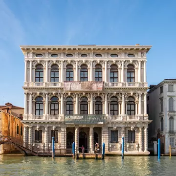 Exterior of the Ca’ Rezzonico, a historic museum, as seen from the water in Venice, Italy.