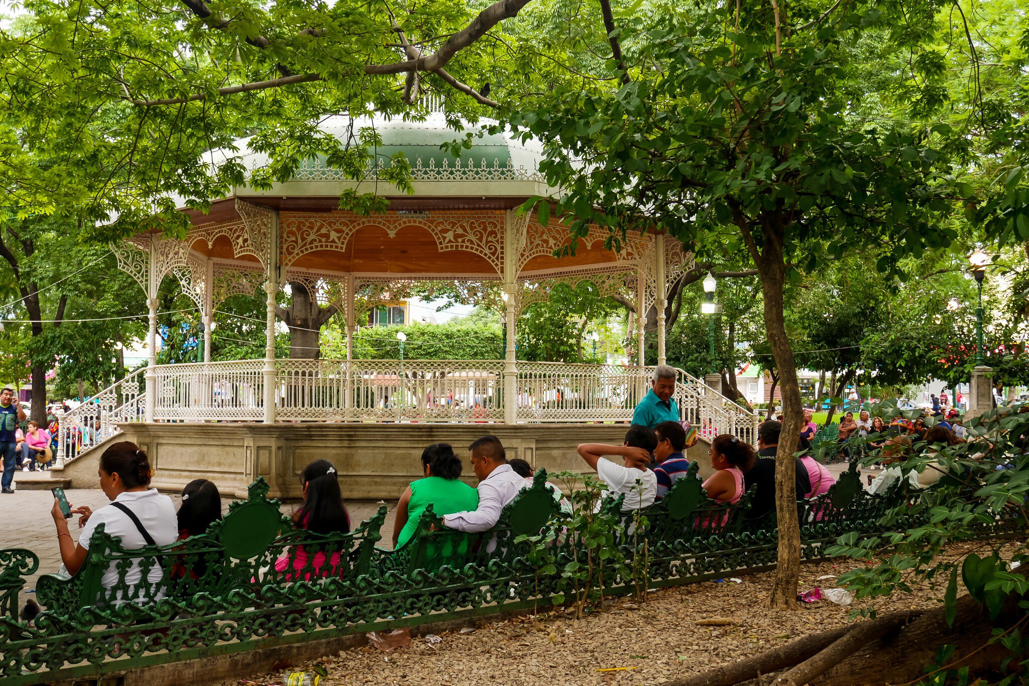 Tuxtla Gutiérrez, Mexico - July 29, 2018 : Locals relaxing on Marimba Park's benches in front of a picturesque bandstand; Shutterstock ID 1341314555;
