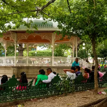 Tuxtla Gutiérrez, Mexico - July 29, 2018 : Locals relaxing on Marimba Park's benches in front of a picturesque bandstand; Shutterstock ID 1341314555;