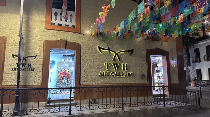 Brown, arched stone entrance to Don Sanchez with Menu stand out front. 