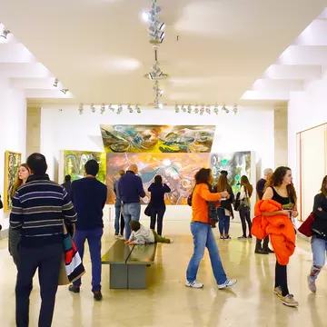 Visitors viewing paintings at the Thyssen-Bornemisza Museum in Madrid, Spain