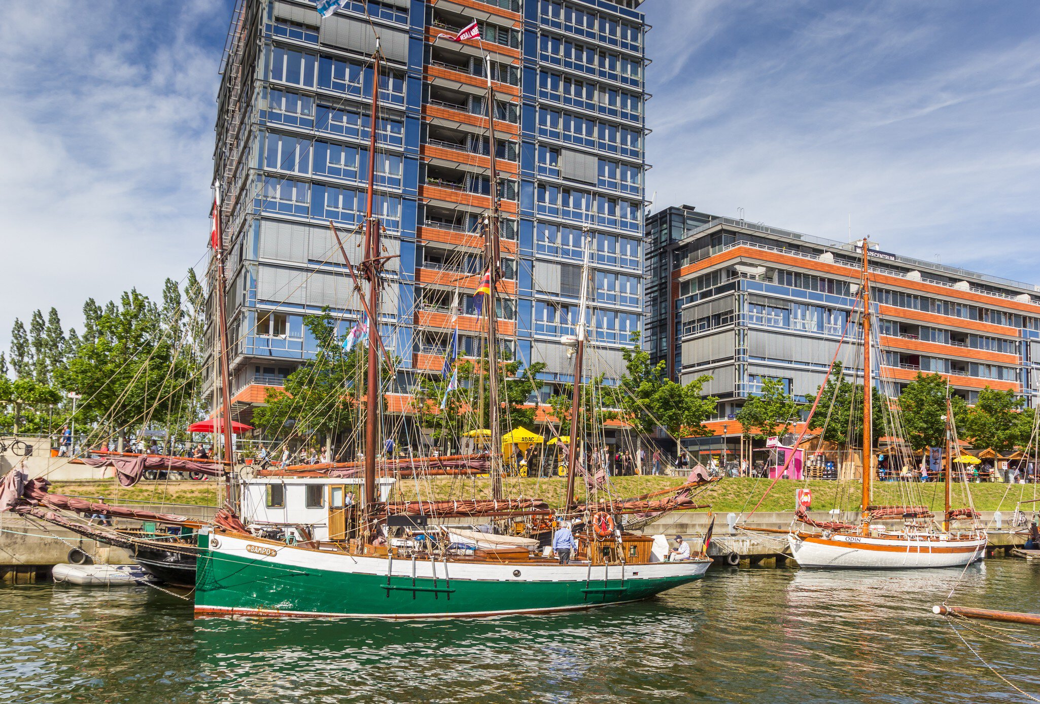 Old ships and modern buildings in the harbor of Kiel, Germany