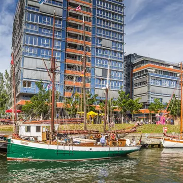 Old ships and modern buildings in the harbor of Kiel, Germany