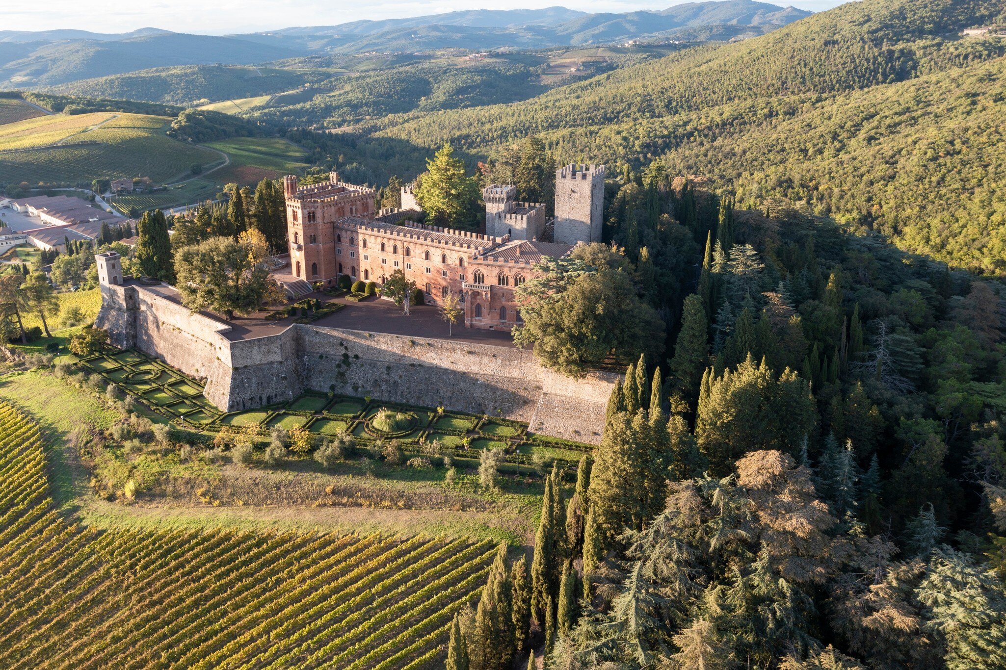 Aerial view of Castello di Brolio, surrounded by vineyards in the Chianti region.