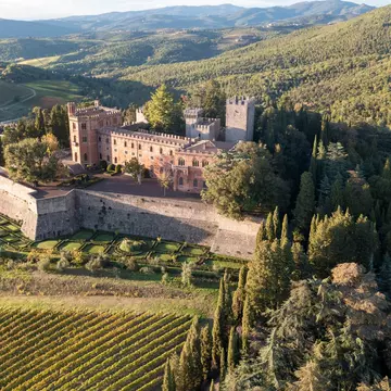 Aerial view of Castello di Brolio, surrounded by vineyards in the Chianti region.