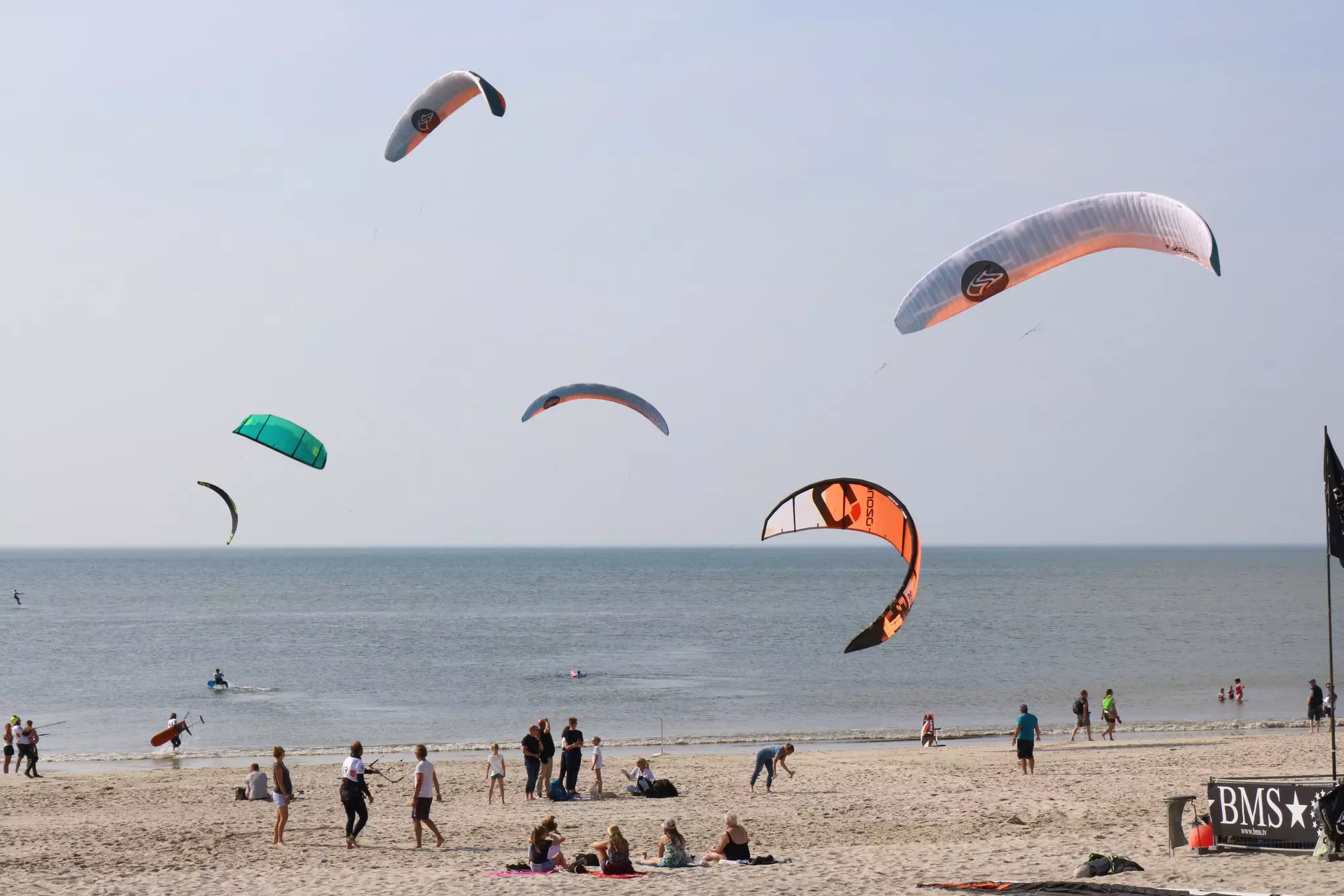 Kitesurfers test their sails on a beach